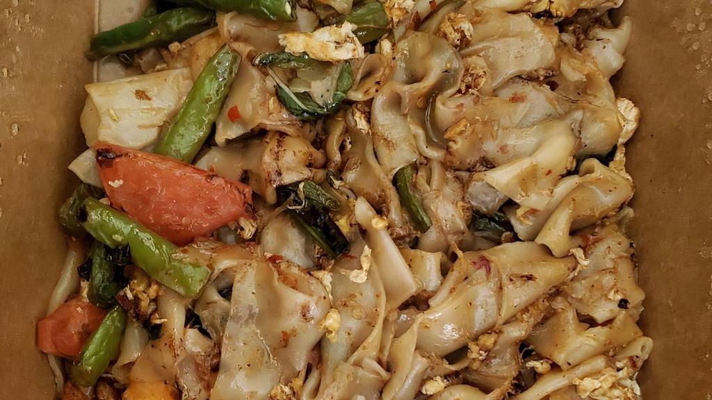 Pad Kee Mao · Vegetarian option. Medium spicy. Flat rice noodles, eggs, green beans, bell peppers, tomatoes, chili, and sweet basil.