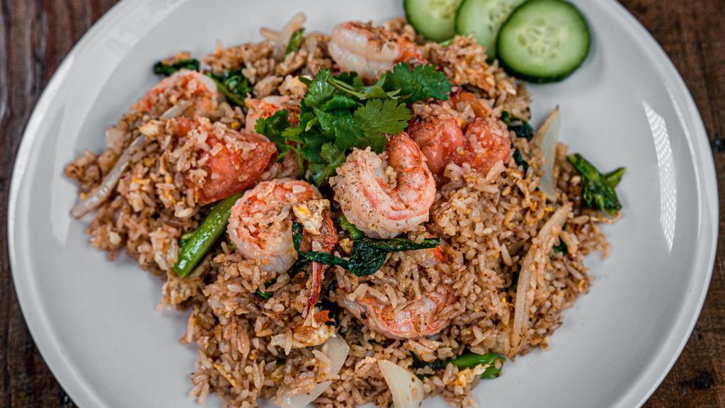 Thai Fried Rice · Vegetarian option. Egg, onions, tomatoes, and Chinese broccoli served with fresh cucumber.
