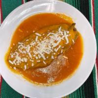 Chile Relleno · Poblano chile stuff with queso fresco, dipped in batter and fried, smother with a homemade t...