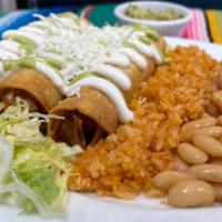 Chicken Flautas Plate · Three rolled up chicken crunchy tacos with a bed of lettuce, topped with sour cream, queso f...