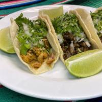 Taco · Choice of meat, cilantro and onions on a Homemade tortillas.