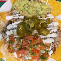 Super Nachos · Homemade tortilla chips, choice of meat, refried beans, cheese, guacamole, sour cream, jalap...