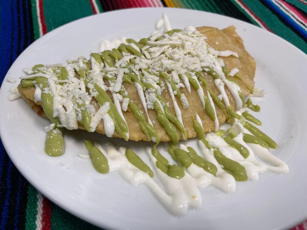 Fried Quesadilla · Fresh handmade corn tortilla stuffed with monterey jack cheese topped with avocado, sour cream, and queso fresco.