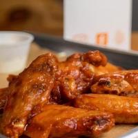 Halal Chicken Wings · Halal chicken wings, adobo seasoning, and choice of sauce.