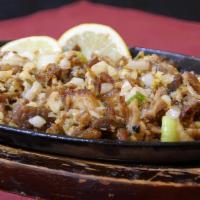 Crispy Pork Sisig · Minced and crispy pork belly fried strips flavored with mayo, jalapeno and onions in soy-lem...