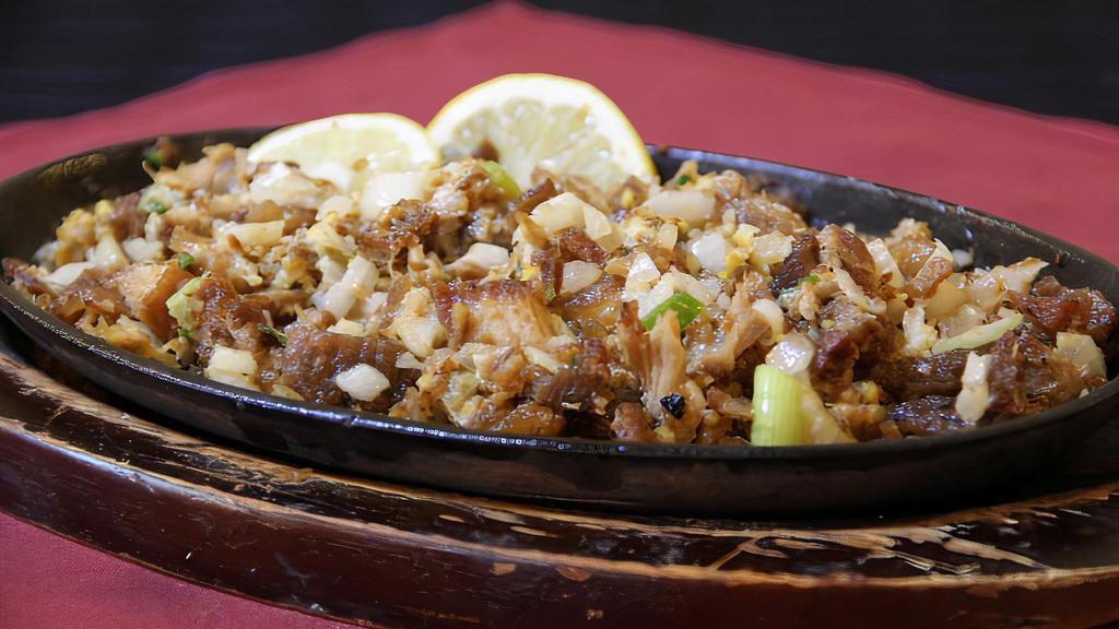 Crispy Pork Sisig · Minced and crispy pork belly fried strips flavored with mayo, jalapeno and onions in soy-lemon sauce. Served in room temperature good for 2-3 people.