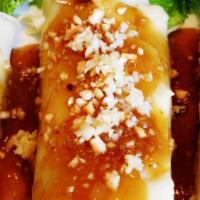 Lumpiang Sariwa · Diced carrots, cabbage, jicama and bean sprouts egg-wrapped and rolled then served with suga...
