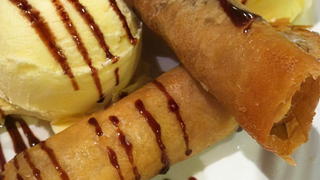 Turon ala Mode · 3pcs of banana fritters on a crispy roll, served with vanilla ice cream and drizzled with chocolate syrup.