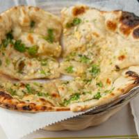 Garlic Naan · Freshly made refined flour bread with fresh garlic baked in clay oven.