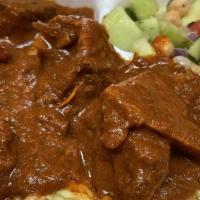 Mutton Curry (Goat Curry) · Medium spicy, gluten free. Served with rice and salad.