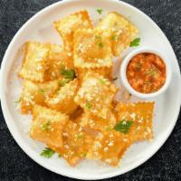 Toasted Ravioli · (Vegetarian) Cheese-filled ravioli breaded and toaste until golden brown. Served with housem...