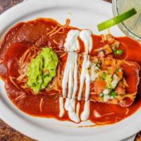Wet Burrito · Choice of meat, whole beans, and rice. Topped with our homemade enchilada sauce, cheese, sou...