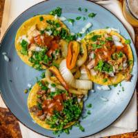 Taco · Soft corn tortillas with choice of meat topped with onion, cilantro, and salsa.