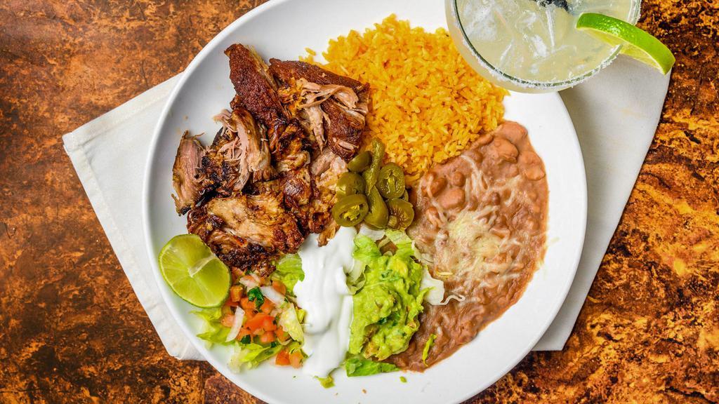 Carnitas · Traditional Mexican style deep-fried pork. Served with guacamole and sour cream. Served with rice, refried beans topped with cheese, and a side of tortillas.