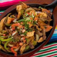Mixed Fajitas · Chicken, beef, and shrimp. Grilled with tomatoes, bell peppers, and onions served with rice,...