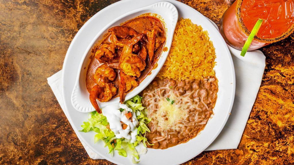 A La Diabla · Spicy. Sautéed prawns in our hot, spicy sauce served with lettuce and pico de gallo. Served with rice, refried beans topped with cheese, and a side of tortillas.