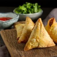 Samosa · Features a delicious, deep-fried pastry filled with potato and served with tamarind and mint...