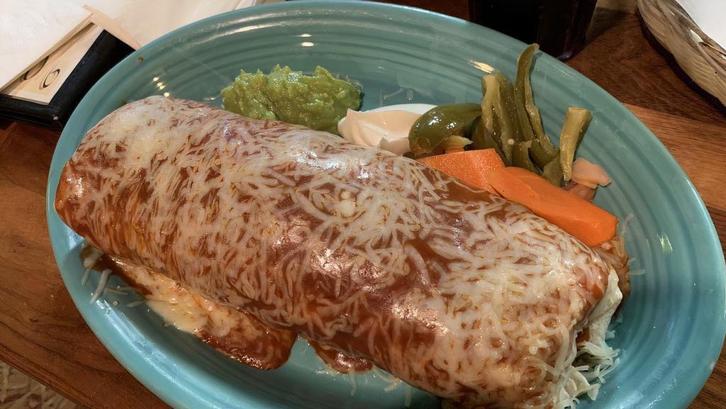 SUPER BURRITO FAMOSO · RICE,BEANS,ONIONS,CILANTRO,TOMATOES, GUACAMOLE ,
SOUR CREAM TOPPED W/ RED ENCHILADA SAUCE & CHEESE.  Additional charge for adding  Grilled Fish or Shrimp.