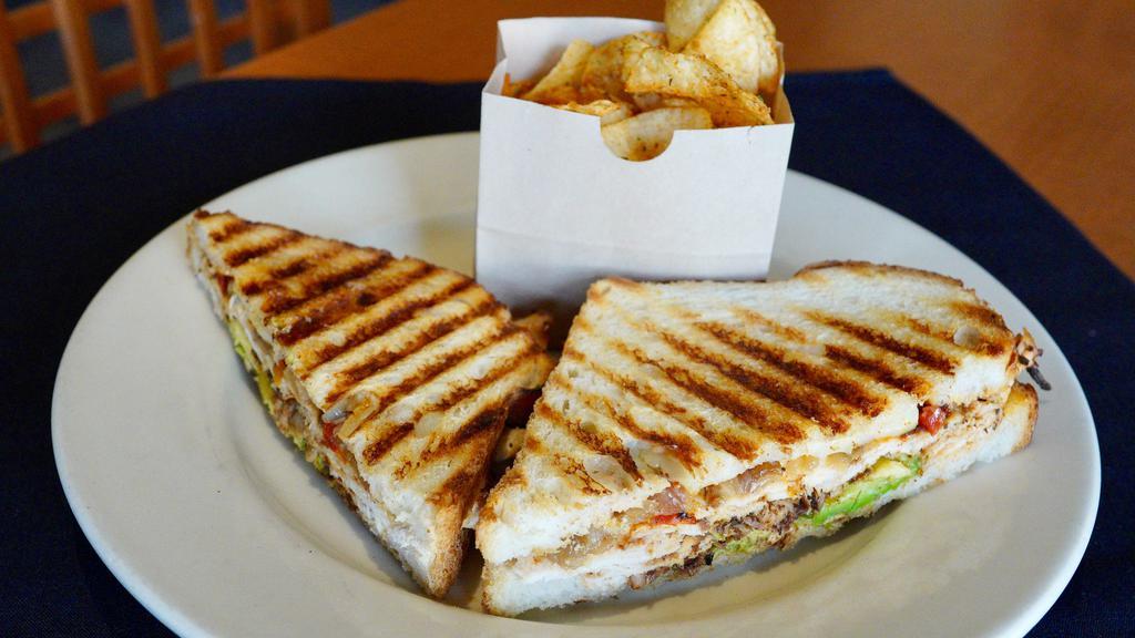 Santa Fe Chicken Panini · blackened chicken, jack cheese, roasted red peppers, caramelized onion, avocado, chili pepper aioli, crisp country bread. 940-1050 cal.
