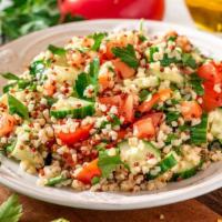 Tabbouleh · Classic mediterranean flavored salad with bulgur, onions, parsley, tomatoes, lemon and toppe...