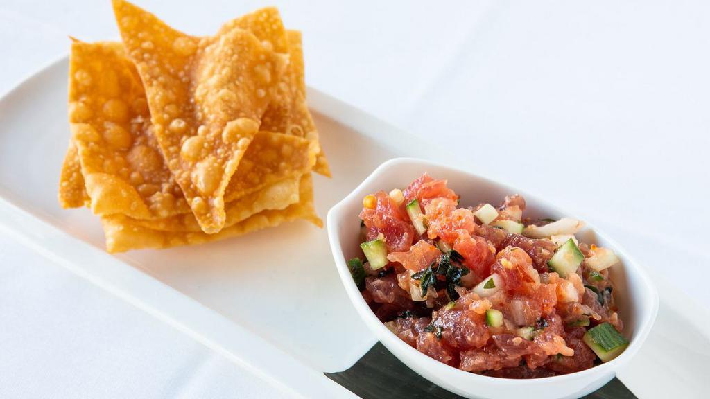 Tuna Tartare · Hawaiian Big Eye Tuna tossed with coconut milk, cucumber, & tobiko; served with crisp wonton chips. Can be made gluten-free with lettuce.