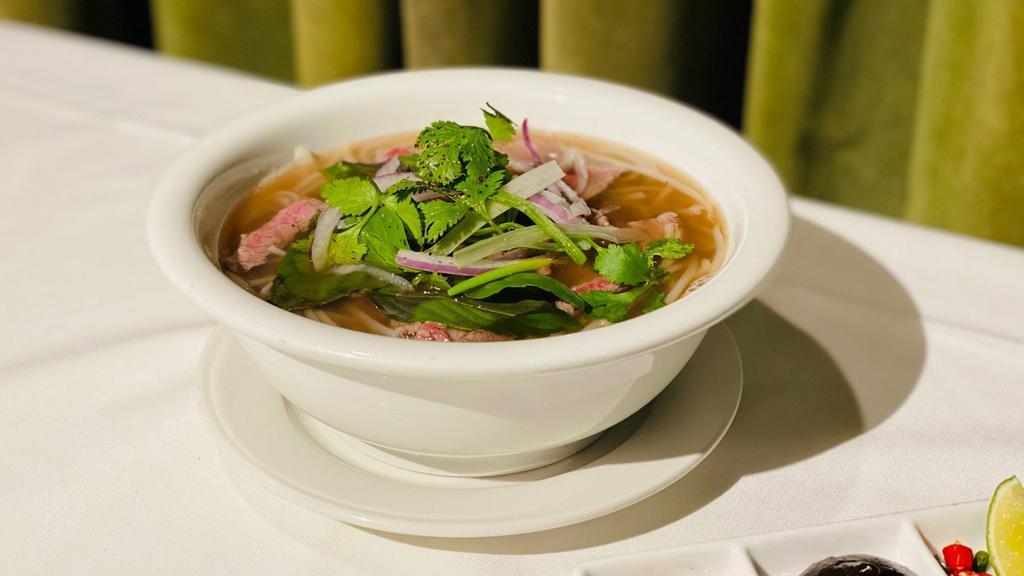 Beef Pho Soup · Sliced Snake River farms American Wagyu beef served with 16-hour beef broth with rice noodles, onion, & herbs. Condiments include lime wedge, hoisin sauce, and sriracha sauce.  (can be gluten-free without hoisin sauce)