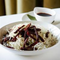 Green Papaya Salad · Shredded green papaya tossed with Thai basil & served with dried sesame beef. Can be made gf.