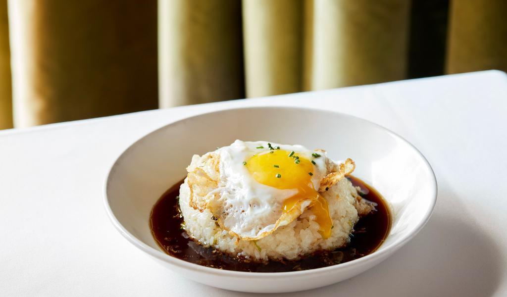 Empress Rice · Vegetarian.  Sticky rice, garlic, leeks, ginger, & egg, served with a sweetened soy drizzle.