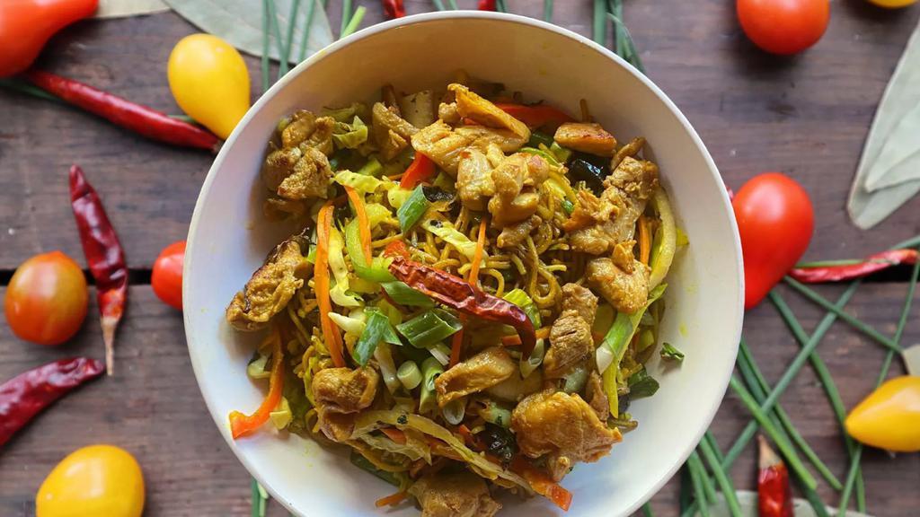 Chicken Singapore Noodles · Spicy Indo-Chinese Hakka noodles, with chicken, eggs, carrots, beans, cabbage, spring onions, flavored with Oriental spices and curry powder.