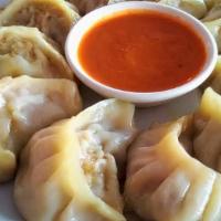 Classic Chicken Momo  · Minced Chicken with a northeastern spice blend, marinated and steamed in a flour wrap. 10 pcs