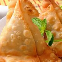 Samosa (2 pc) · Fried pastry shells, flavoured potatoes, served with tamarind, and mint chutneys.