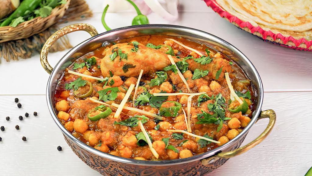 Chicken Cholay · Chicken cooked with garbanzo beans and traditional choley spices.