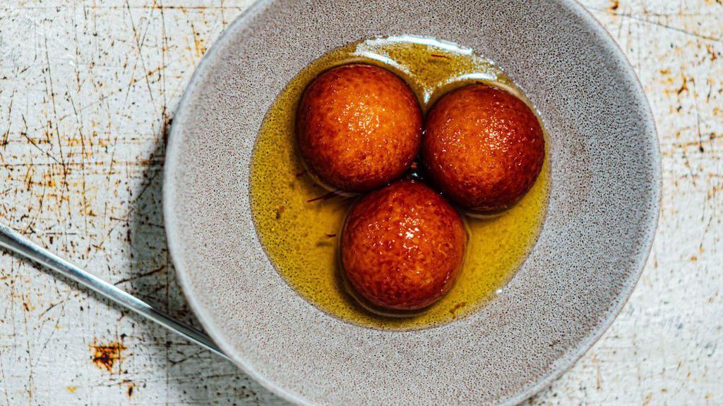 Gulab Jamun · Fried milk dumpling soaked in a flavorful rose and cardamom syrup.
