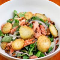 Salade de Truite Fumee · Flakes of smoked trout with mâche, fingerling potato coins, shaved red onion, & toasted pump...