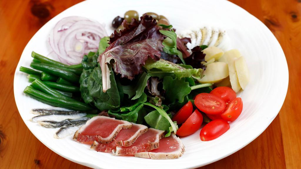 Salade Nicoise · Organic mixed green with Ahi tuna, olives, potatoes, green beans, tomatoes and hard boiled egg & fresh anchovies .