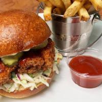 Buffalo Fried Chicken Sandwich · Breaded chicken thigh, home-made hot sauce, coleslaw, dill pickles, aioli on a house baked b...