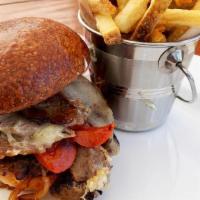 Tri Tip Cheese Steak · Tri tip, grilled onions and red peppers, cheddar cheese, lemon aioli on a house baked brioch...