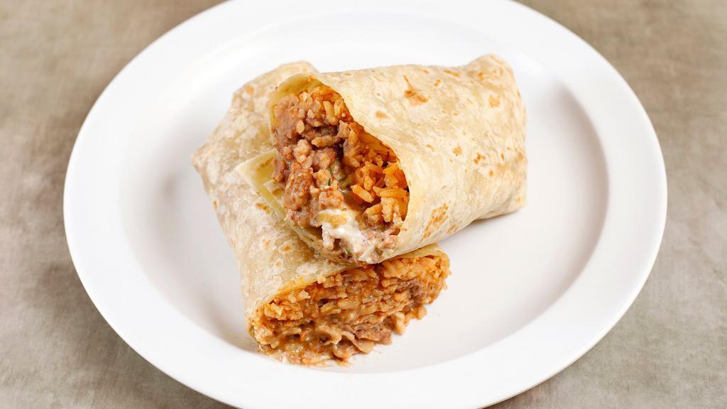 Burrito · A flour tortilla stuffed with rice, beans, choice of chicken, beef or al pastor and choice of green or red sauce.