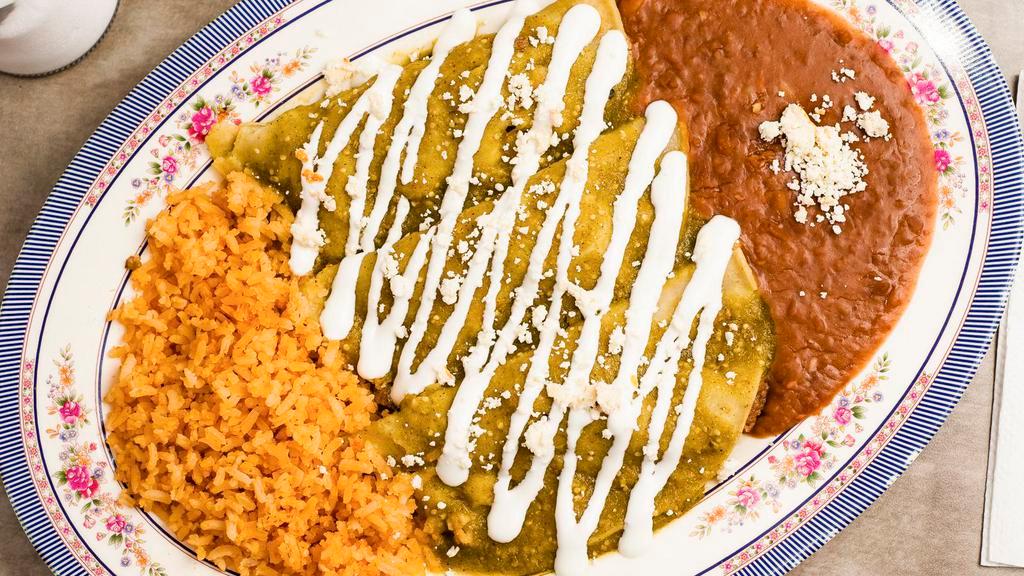 Enchiladas Verdes · Three corn tortillas stuffed with shredded chicken. Served with rice and beans. Topped with our green sauce, a scoop of sour cream and cheese.