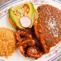 Camarones a La Diabla · Large jumbo prawns prepared with a spicy sauce. Served with rice, beans, guacamole, and corn...