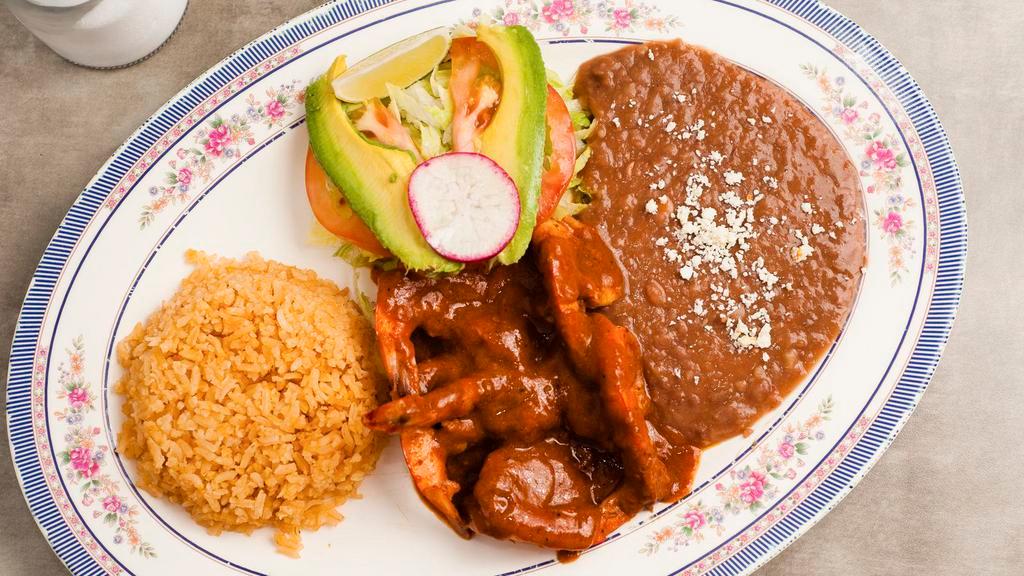Camarones a La Diabla · Large jumbo prawns prepared with a spicy sauce. Served with rice, beans, guacamole, and corn tortillas.
