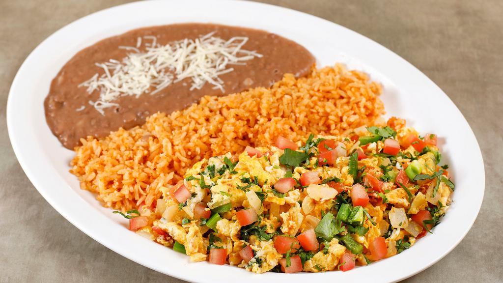 Huevos a La Mexicana · Mexican-style eggs cooked and scrambled with onions, tomatoes, and jalapeños. Served with rice, beans, and corn tortillas.