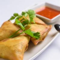 Samosas (Vegetarian) · Flour turnover filled with potatoes, red onions, peas, carrots, and a blend of unique spices...