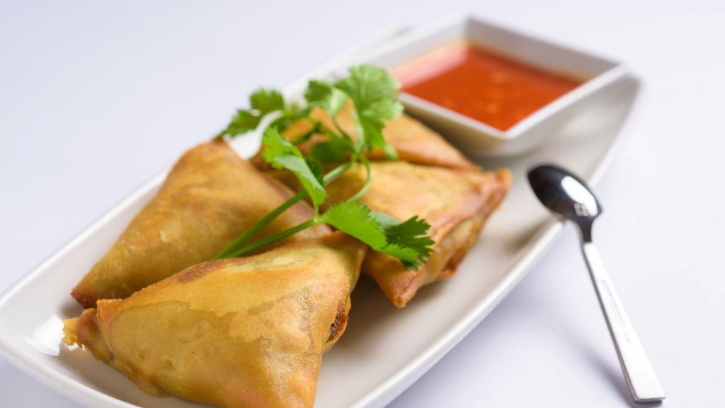 Samosas (Vegetarian) · Flour turnover filled with potatoes, red onions, peas, carrots, and a blend of unique spices served with special house sauce.
