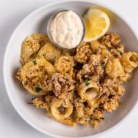 Golden Fried Calamari · Golden-fried calamari and lemon wheels served with the house-made tartar sauce.. CANNOT BE M...