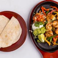 Shrimp Fajitas · Six shrimp with bell peppers and onions cooked in chili-lime butter. Served with flour torti...