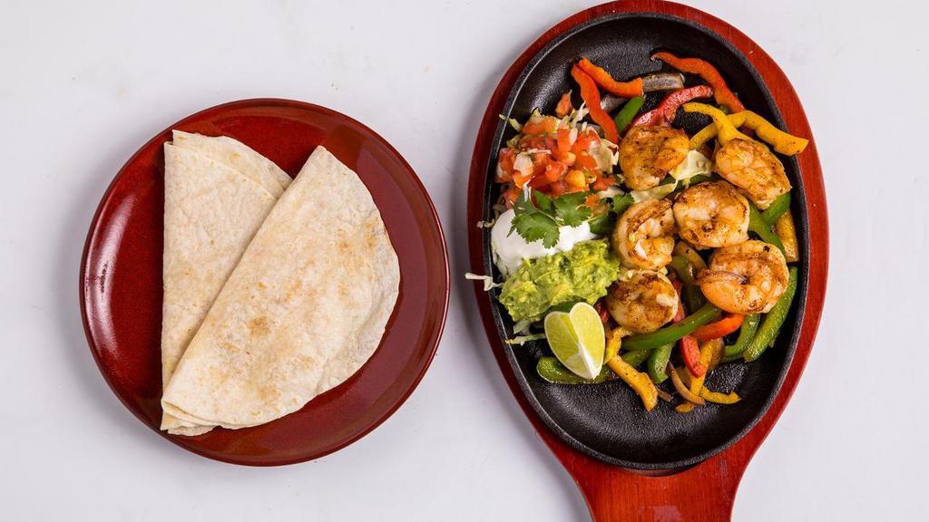Shrimp Fajitas · Six shrimp with bell peppers and onions cooked in chili-lime butter. Served with flour tortillas, guacamole, sour cream, and pico de gallo on the side.