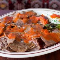 Iskender Kebap · Meat or chicken doner in tomato sauce over cubed bread. Served with yogurt, tomato sauce, an...