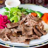 Doner · Vertically roasted and sliced ground lamb and beef. Served with rice and salad.