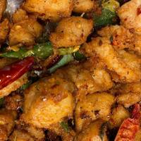 5. Kung Pao Chicken · Rice served with fried fish with chili pepper.